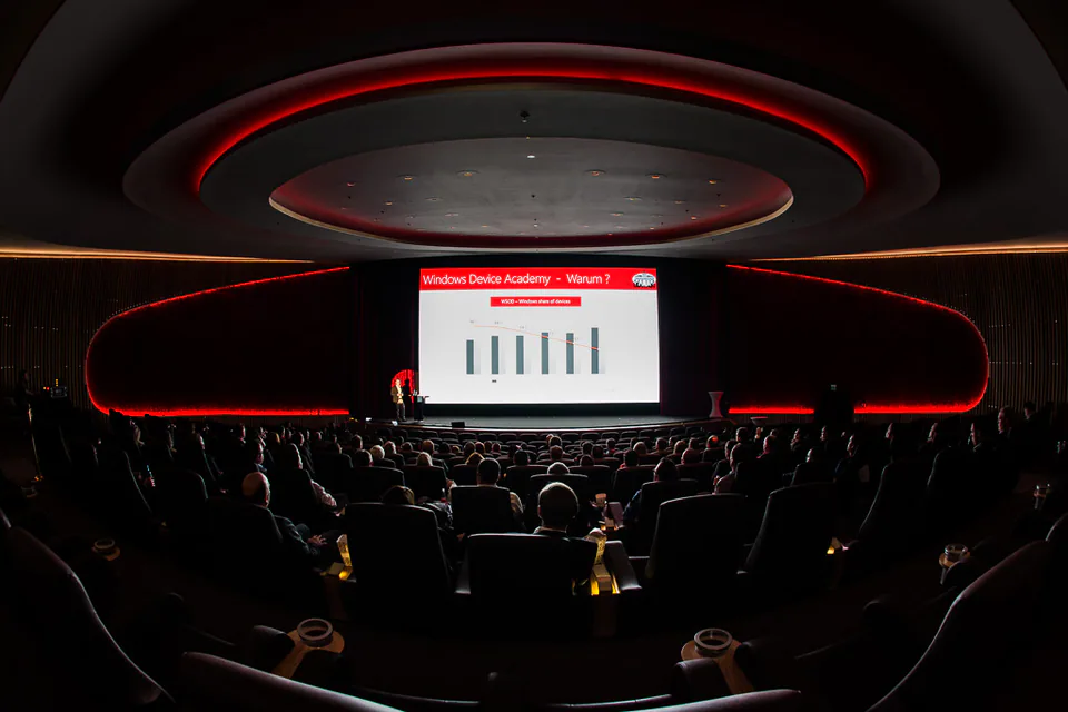 Presentation on a screen in a darkened hall