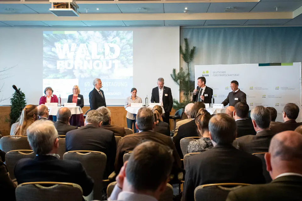 Panel discussion in front of a seated audience