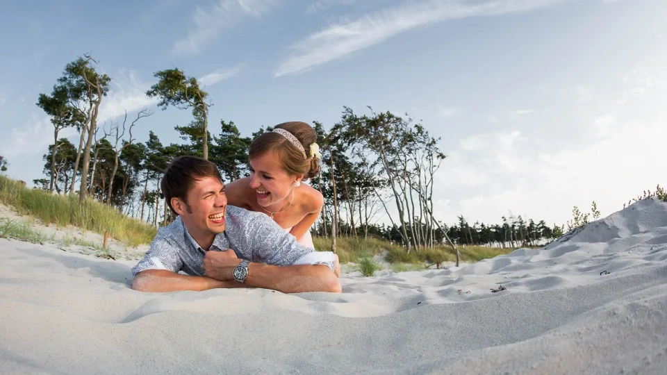 A wedding couple on the sand at sunset on the Weststrand beach on the Darß peninsula
